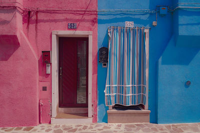 Pink and blue houses on sunny day