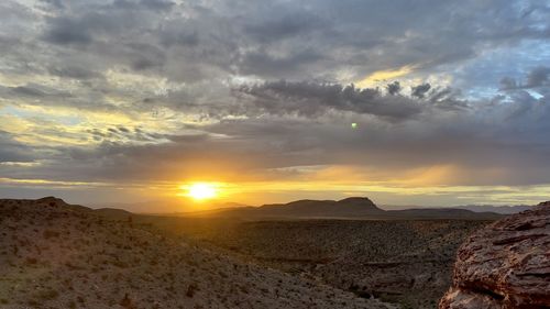 Scenic view of desert against sky during sunset