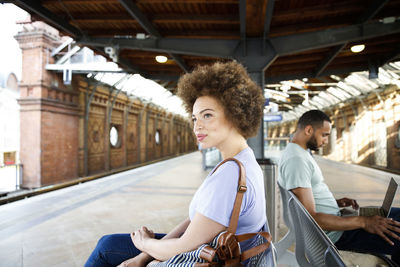 Young woman using mobile phone while sitting in bus