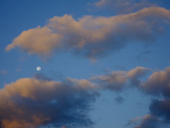Low angle view of moon in sky at sunset