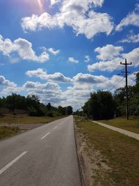 Road amidst trees against sky