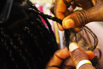 Cropped hands braiding hair