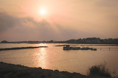Scenic view of river against sky during sunset