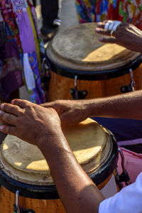 Cropped hands of people playing musical instrument