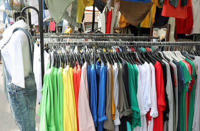 Stand of clothes at outdoor market in the street