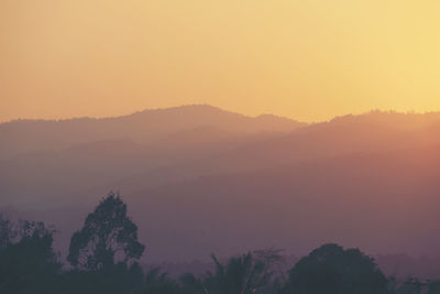 Scenic view of silhouette mountains against sky during sunset