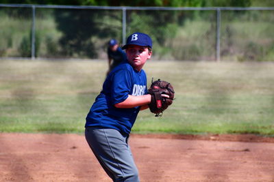 Full length of boy standing on field