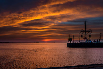 Scenic view of sea against orange sky