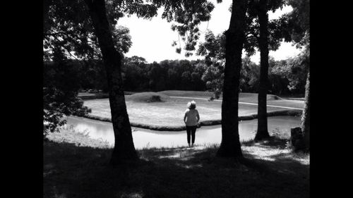 Silhouette of woman walking on field