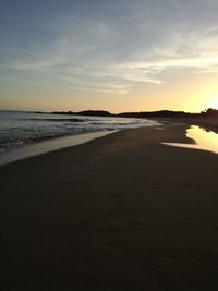 Scenic view of beach against sky during sunset