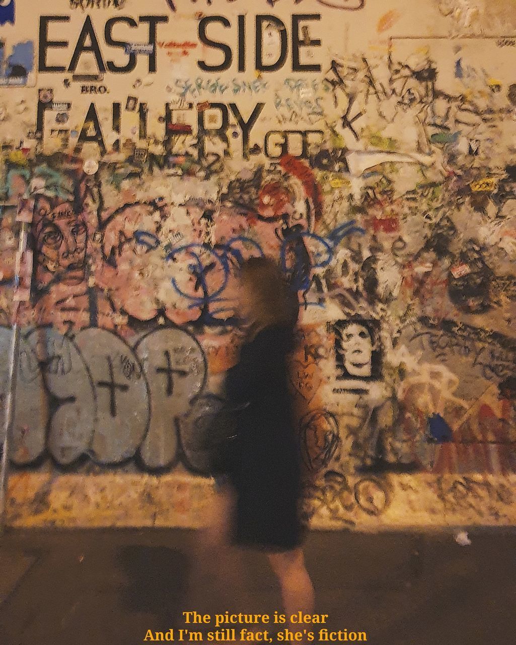 PORTRAIT OF WOMAN WITH GRAFFITI ON WALL
