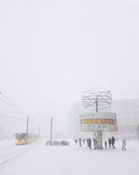 Information sign on snow against clear sky