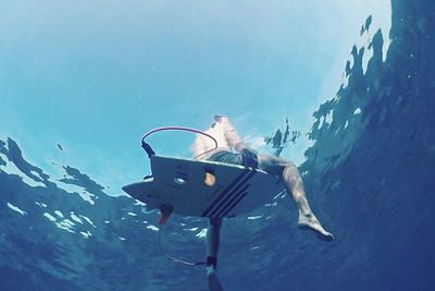 Low angle view of man swimming in sea