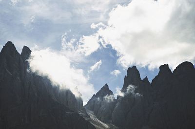 Scenic view of mountains against cloudy sky
