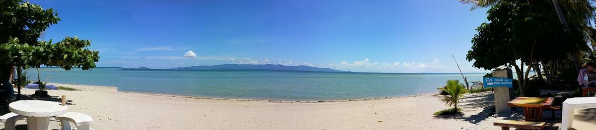 Scenic view of beach against blue sky