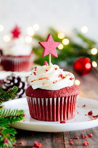 Close-up of cupcakes on table against trees