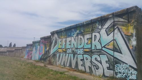 Graffiti on wall in city against sky