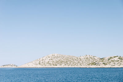 Scenic view of sea against clear blue sky