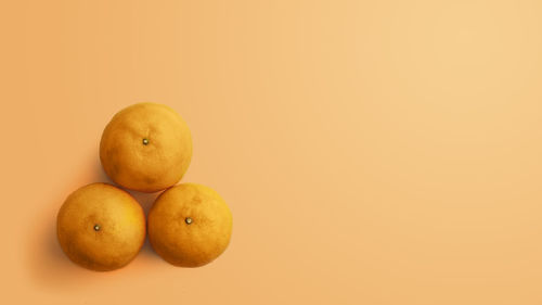 Close-up of oranges against yellow background