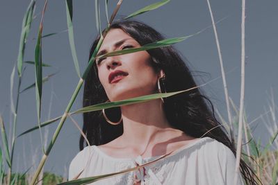 Portrait of young woman looking away outdoors