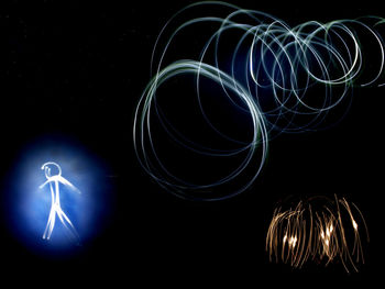 Low angle view of light trails at night