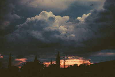 Low angle view of silhouette buildings against sky during sunset