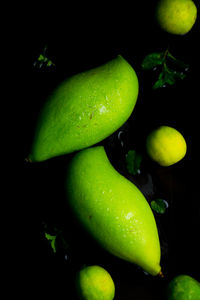Close-up of green chili pepper against black background