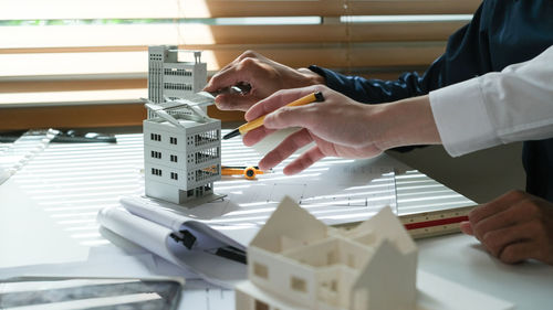 Cropped hands of man working on table