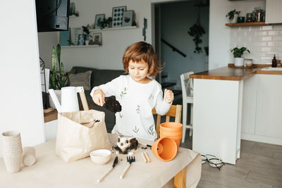 Boy and cat on table at home