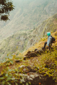 Rear view of man climbing on mountain