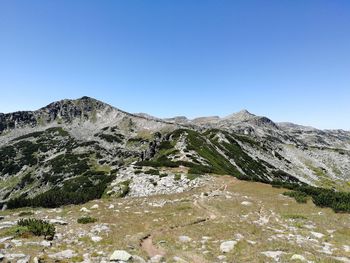 Low angle view of mountain against clear blue sky