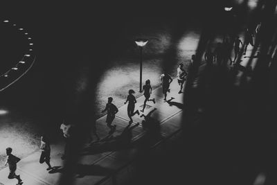 High angle view of people walking on road in city