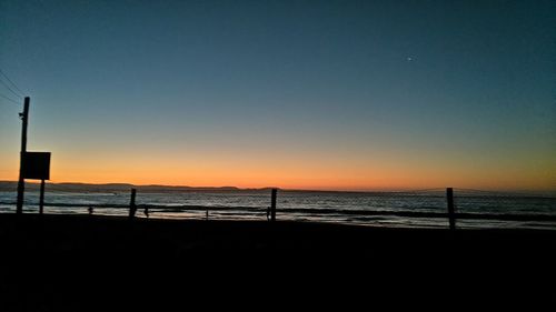 Scenic view of sea against clear sky during sunset