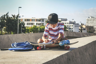 Rear view of boy sitting outdoors