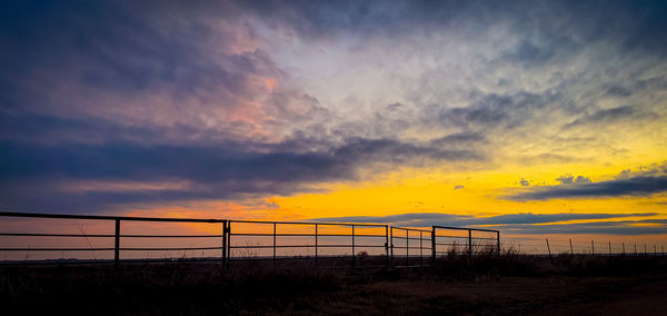 Scenic view of silhouette beach against sky during sunset