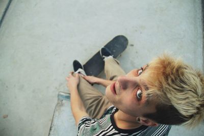 Directly above portrait of man with skateboard