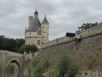 View of arch bridge and building against sky