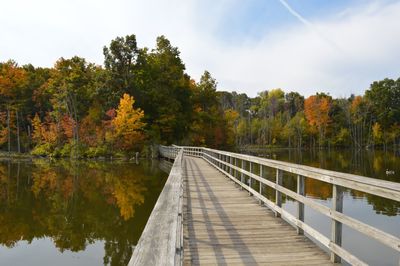 Footbridge over lake during autumn