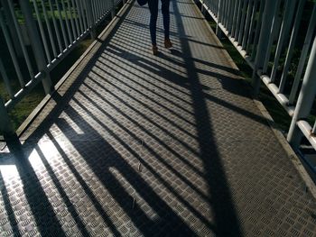 Low section of person walking on footbridge