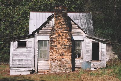 Exterior of abandoned house on field