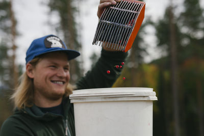 Portrait of smiling man holding hat