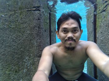 Portrait of young man swimming in water