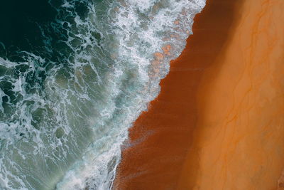 High angle view of sea waves at shore