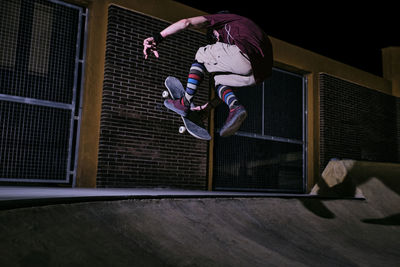 Young white man jumping on his skateboard