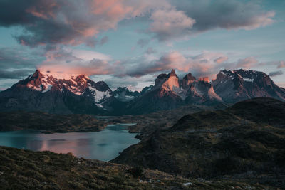 Scenic view of snowcapped mountains against sky during sunset