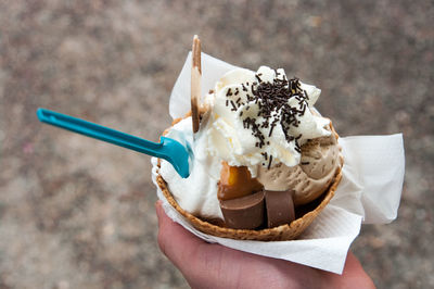 Close-up of hand holding ice cream