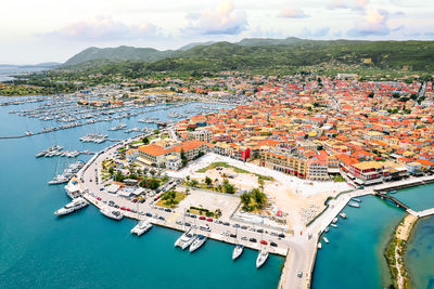 High angle view of townscape by sea against sky