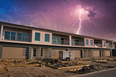 Low angle view of lightning against buildings in city