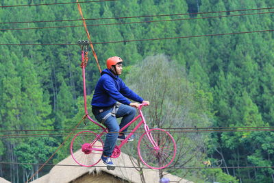 Man riding bicycle on rope