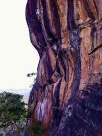 Low angle view of rock formation against sky